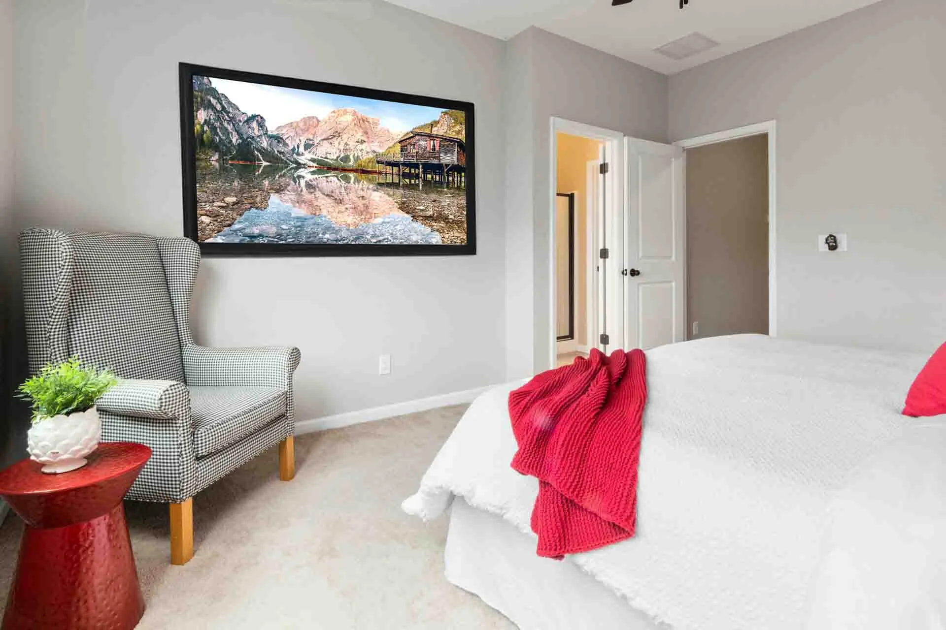 Furnished bedroom with a large landscape framed poster on the wall displaying lago di braies is the Italian alps