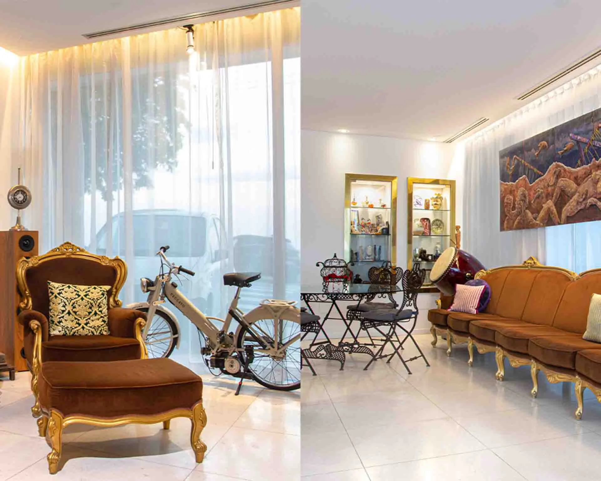 Two large ornate sofas are seen in white tiled seating areas, there is an antique Italian motorcycle behind the sofa by a window